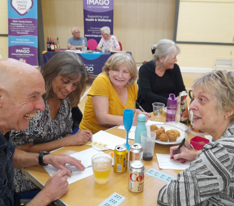 Quiz team sat around a table laughing